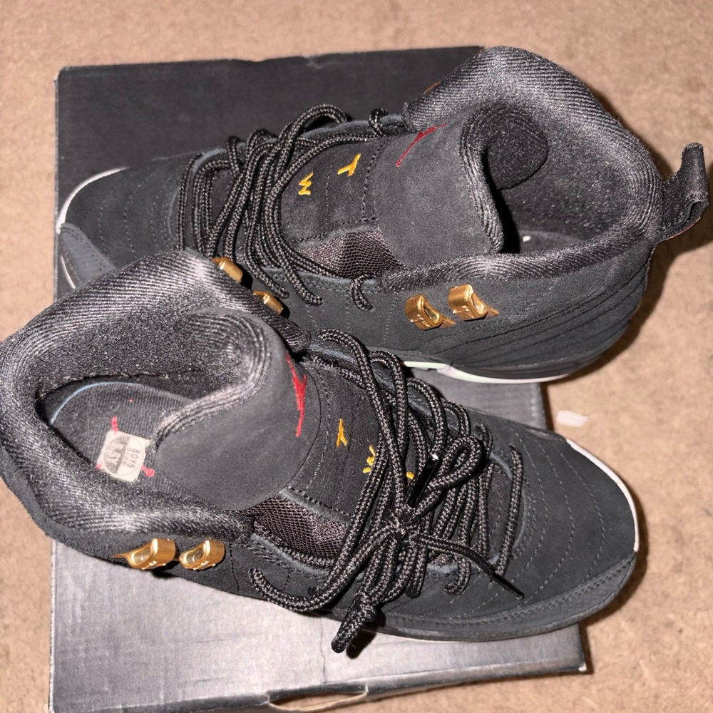 Jordan Women's Black High-Top Sneakers with Gold and Red Accents
